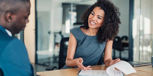 Image of job seeker and consultant discussing job search strategy and resume improvement